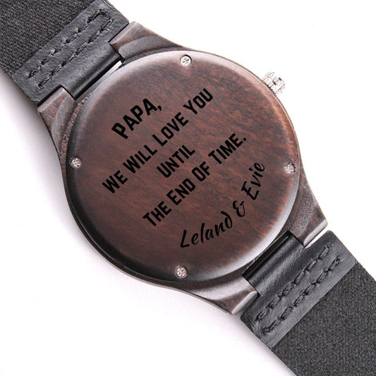 back side of wooden watch displayed with customized engraving on white background