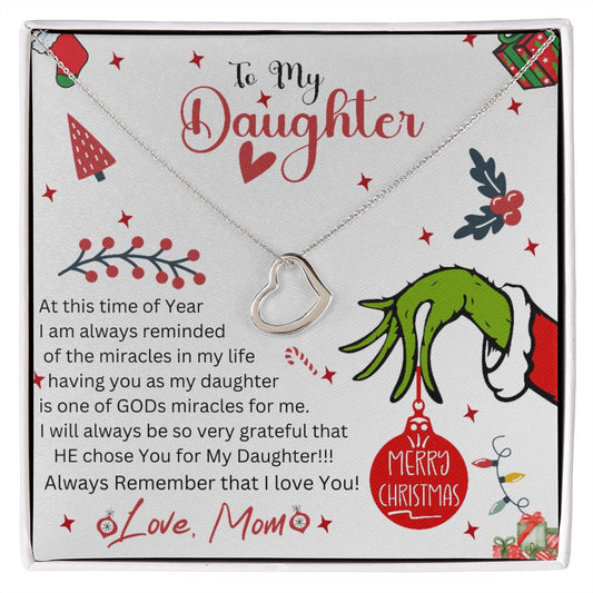 delicate heart necklace displayed on message card with christmas ornamentation