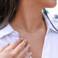 delicate heart necklace displayed as being worn by woman