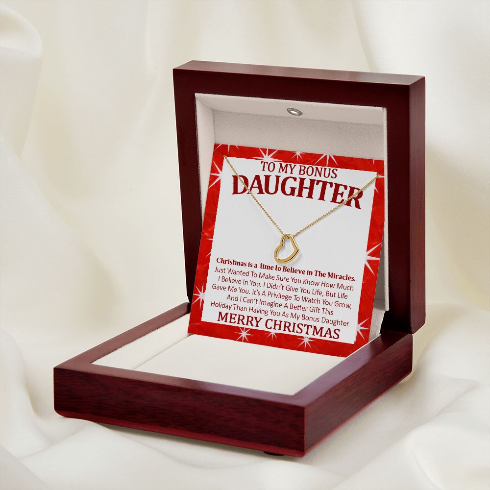 delicate heart necklace and message card displayed off center stananding up in led lit mahogany box